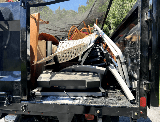 Junk sitting in the back of a truck ready to be hauled away