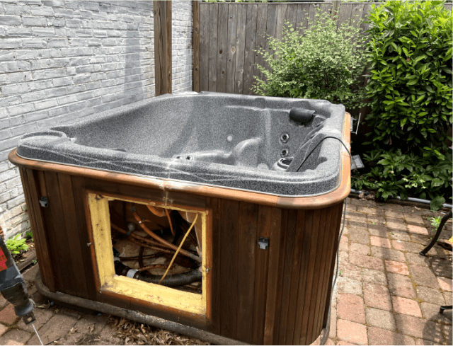 An old hot tub that needs to be dismantled and disposed of